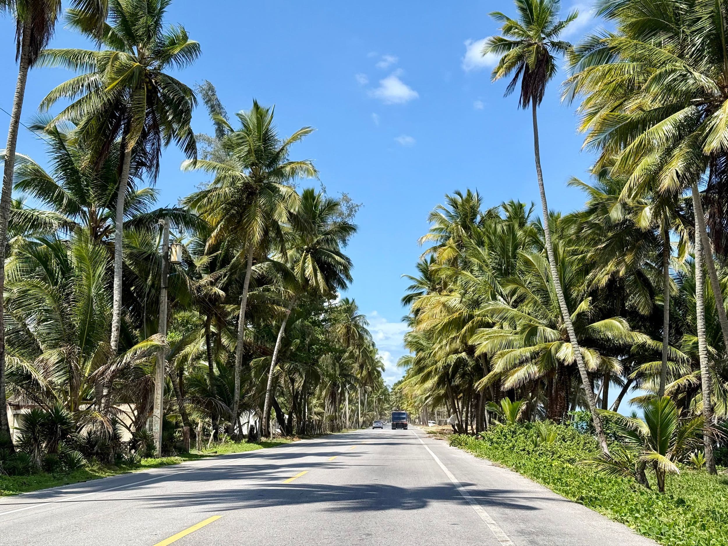 Road in Cabarete, Dominican Republic, with cars and motorcycles